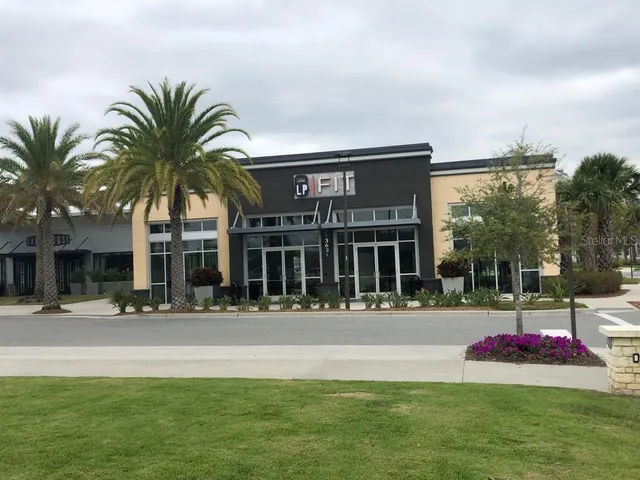 a view of a house with swimming pool and sitting area