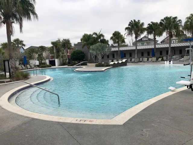 a view of swimming pool with outdoor seating and city view