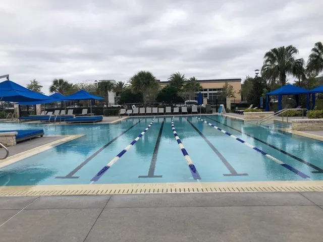 a swimming pool with outdoor seating and yard