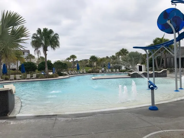 a view of a house with a yard and lake view