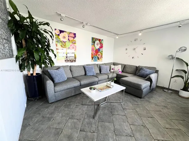 a room with a table chairs and wooden floor