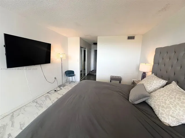 a large bed sitting in a bedroom and table