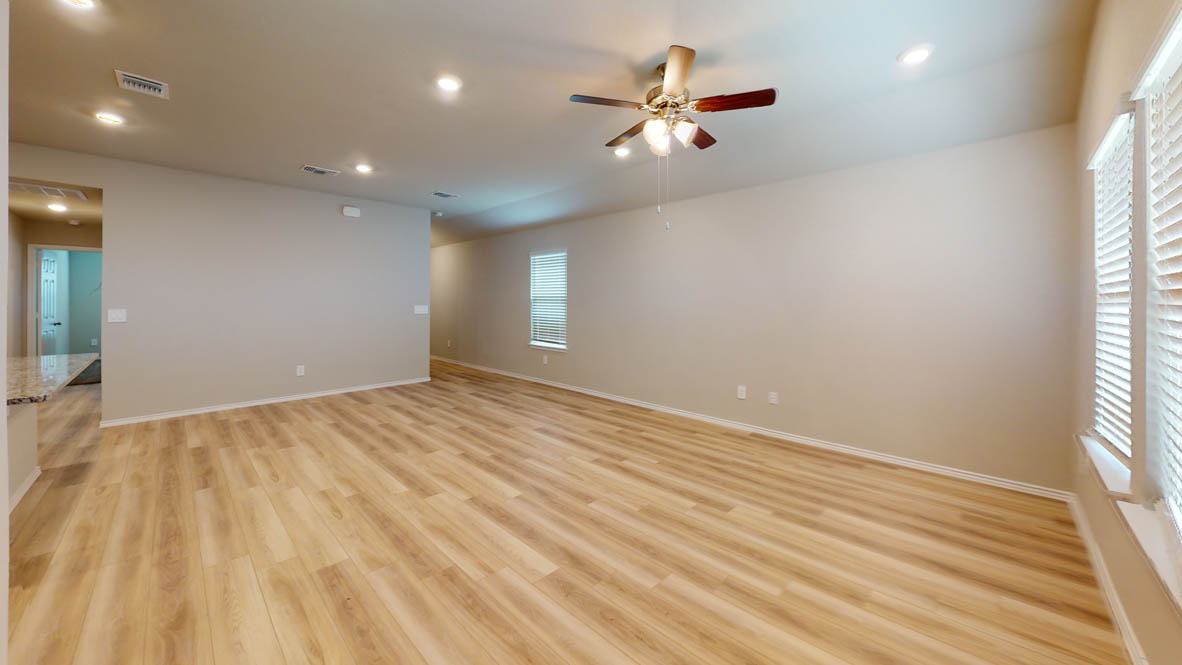 561 Hector Loop Georgetown, TX 78626 - Photo 10 of 30 an empty room with wooden floor and windows