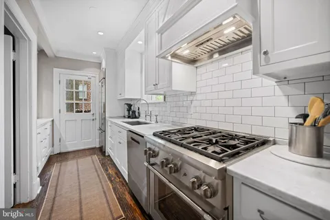 a bathroom with a granite countertop sink a mirror and a shower