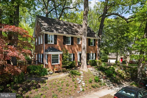 front view of a house with a tree