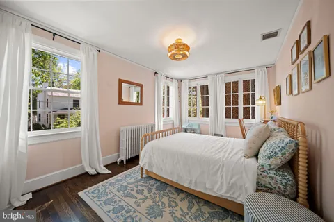 a living room with furniture a flat screen tv and a floor to ceiling window