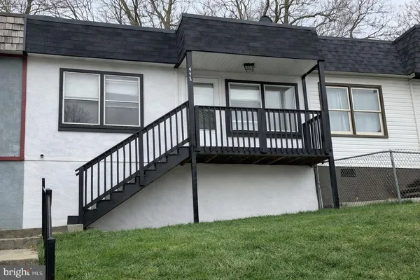 a view of backyard with a deck and a garden