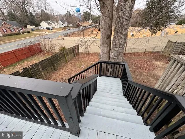 a view of balcony with wooden floor and fence
