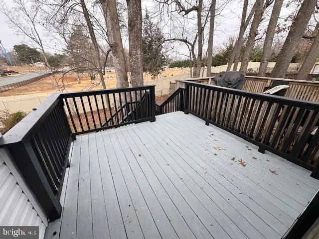 a view of balcony with wooden floor and fence and floor to ceiling window