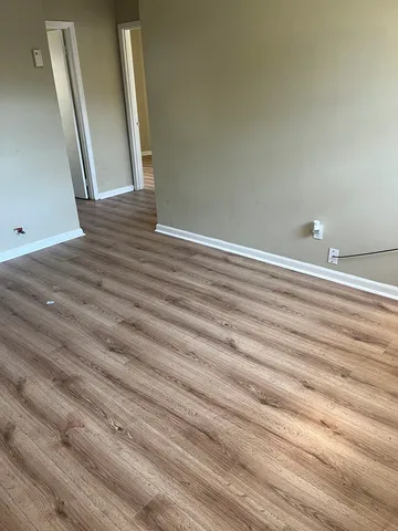 a view of a closet with wooden floor