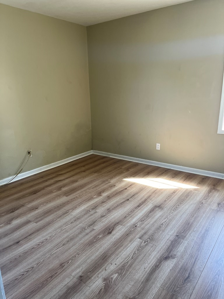 1422 23rd Street, Unit A Columbus, GA 31901 - Photo 4 of 8 a view of an empty room with wooden floor