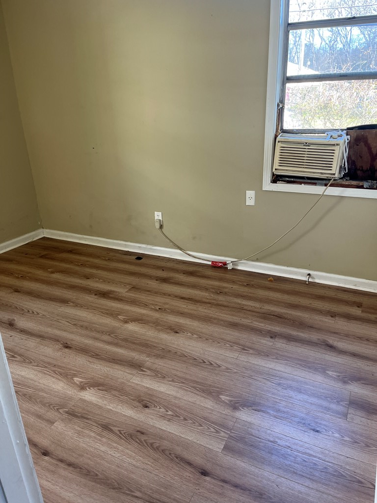 1422 23rd Street, Unit A Columbus, GA 31901 - Photo 5 of 8 a view of a room with wooden floor and windows