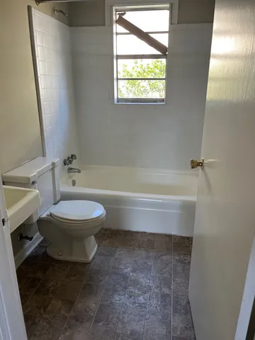 a bathroom with a toilet and a bathtub