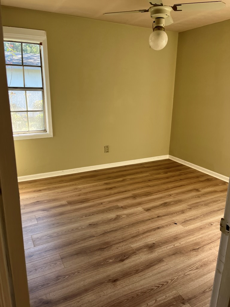 1422 23rd Street, Unit A Columbus, GA 31901 - Photo 8 of 8 a view of a room with wooden floor and white walls