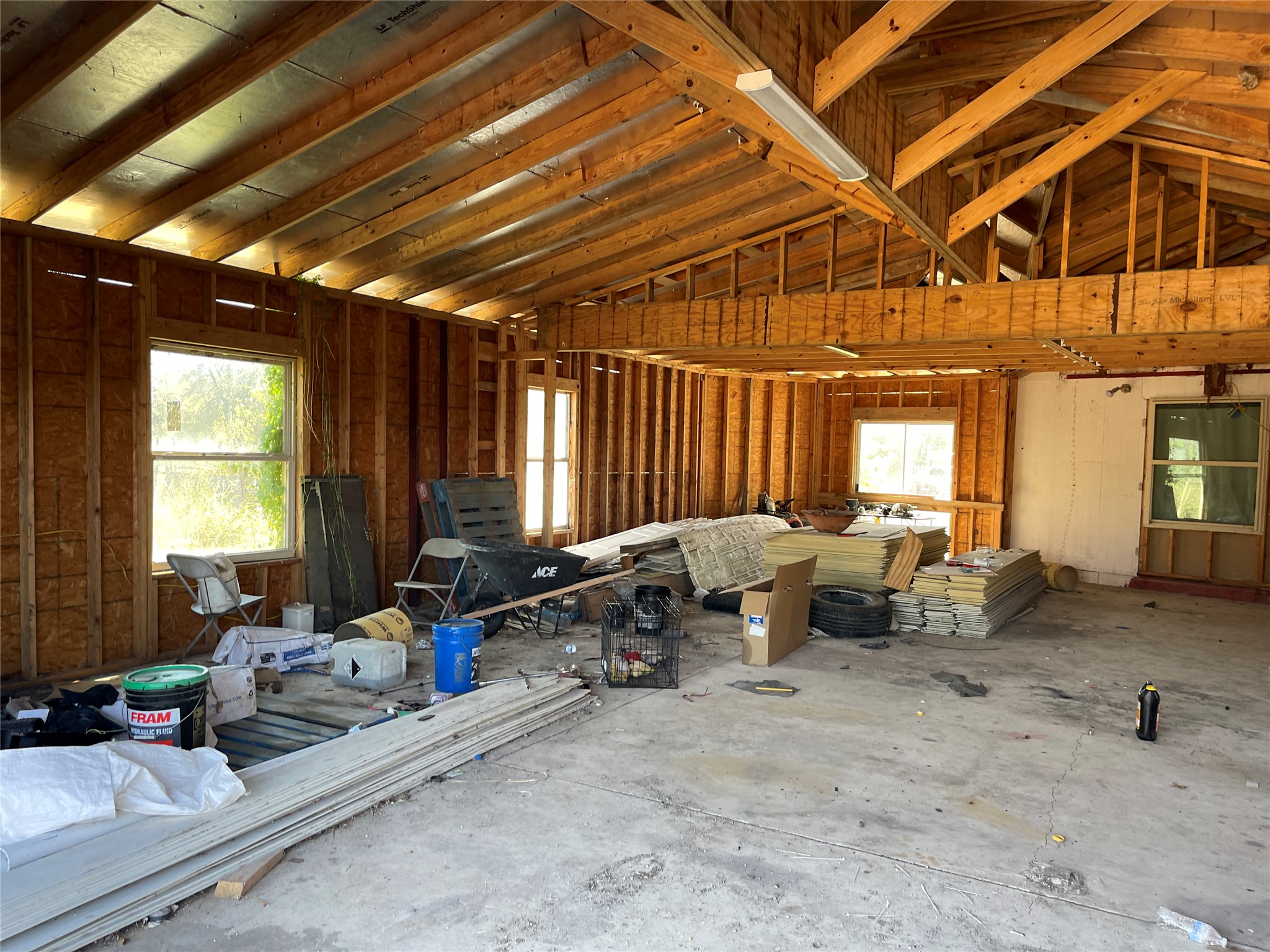 12212 Ballerstedt Road Elgin, TX 78621 - Photo 19 of 29 Exposed wood framing and concrete flooring define this unfinished interior space.