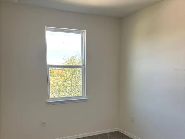 a bathroom with a shower curtain and a toilet