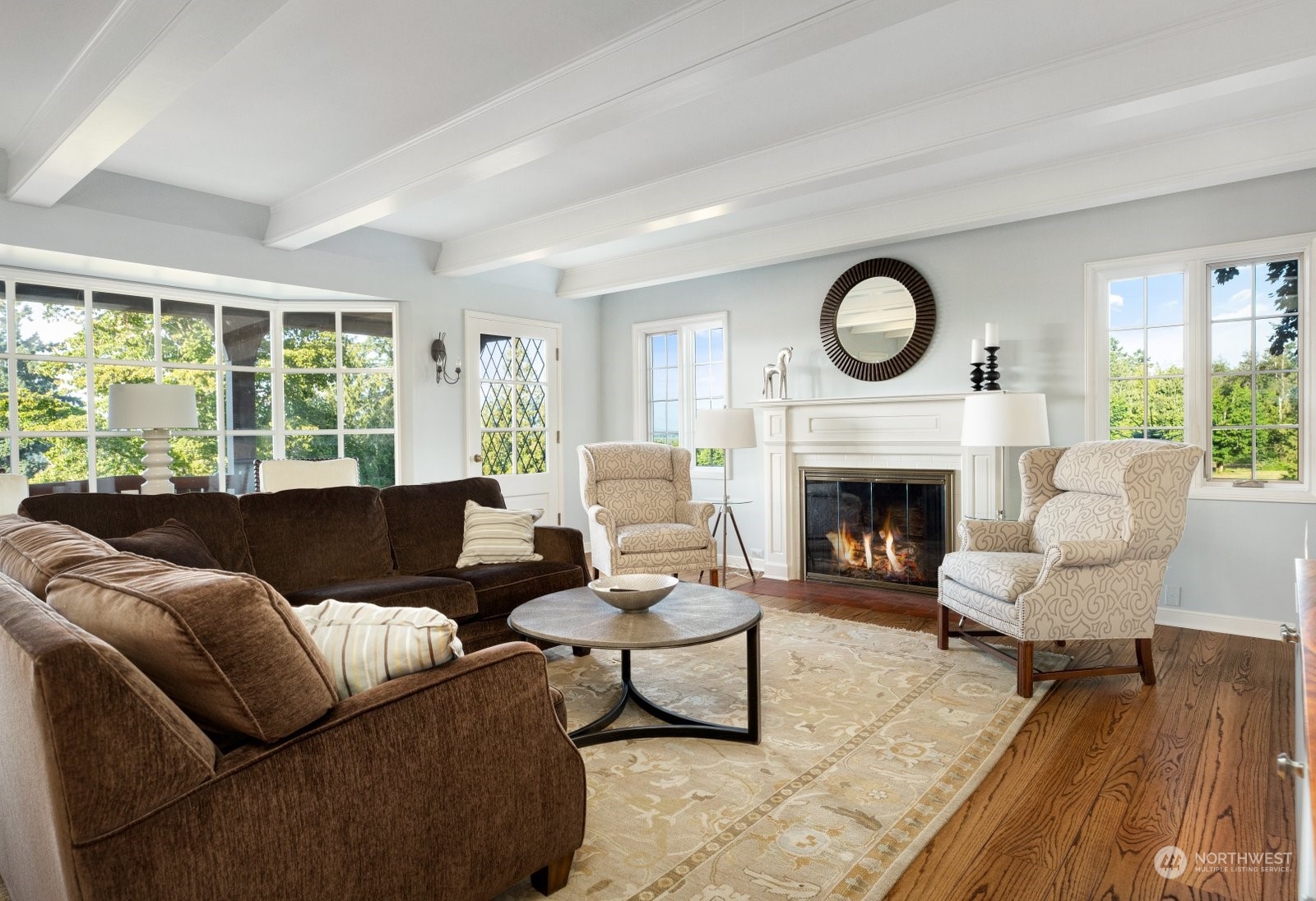 15253 Josh Wilson Road Burlington, WA 98233 - Photo 5 of 40 a living room with furniture a rug a fireplace and a large window
