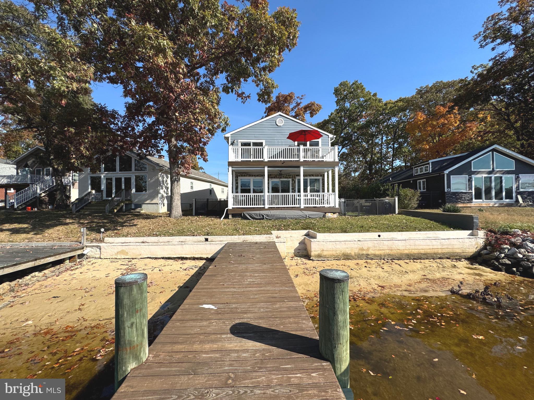 Waterside elevation of house, beach, pier