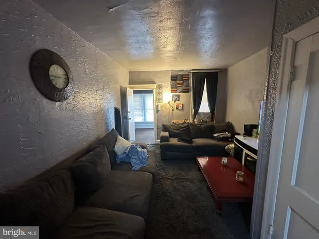 a living room with furniture and a mirror