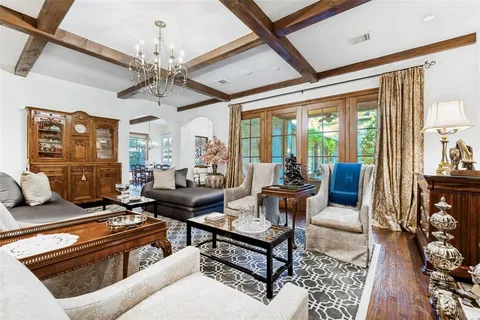 a living room with furniture and a chandelier