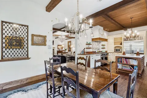 a view of a dining room with furniture and a chandelier