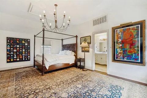 a bedroom with a bed and a painting on the wall