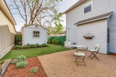a view of a backyard with table and chairs and a fire pit