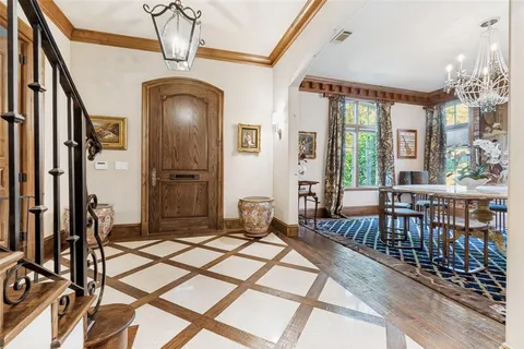 a bedroom with furniture large windows and a chandelier