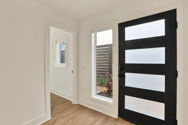 a view of front door with wooden floor