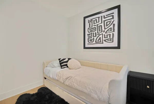 a bedroom with a bed and a wall painting