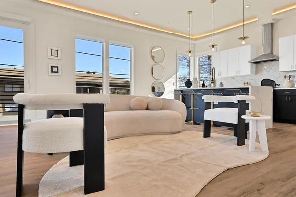 a living room with furniture a rug and white walls