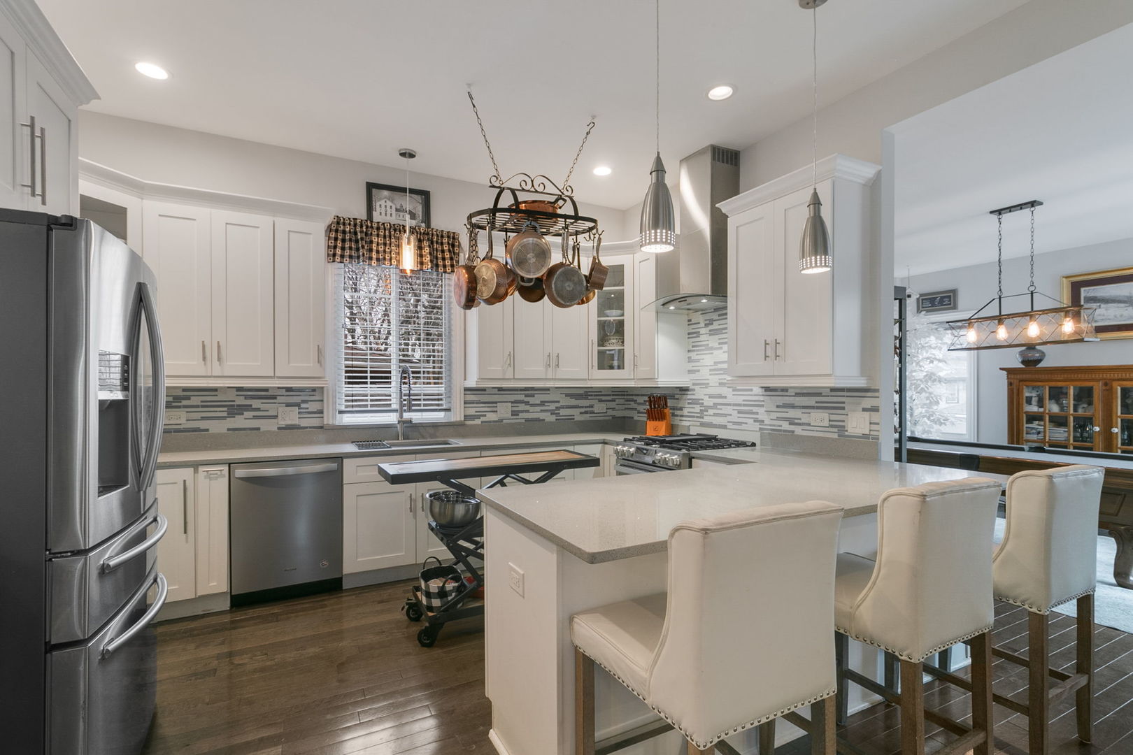 3239 Wesley Avenue Berwyn, IL 60402 - Photo 6 of 10 a kitchen with a sink a center island stainless steel appliances and cabinets
