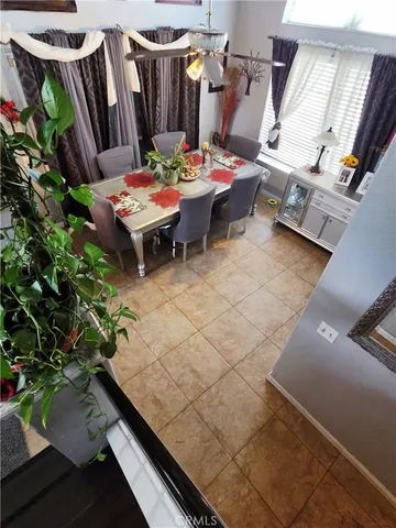 a living room with furniture and painting on the wall