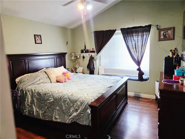 a spacious bedroom with a bed and a dresser in it
