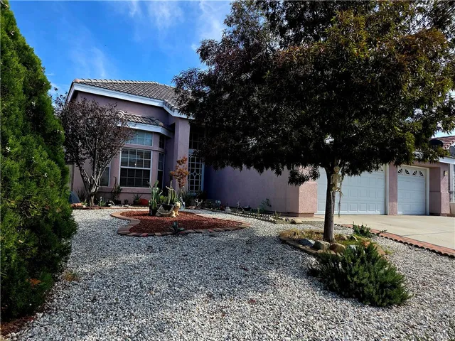 a view of a house with backyard and sitting area