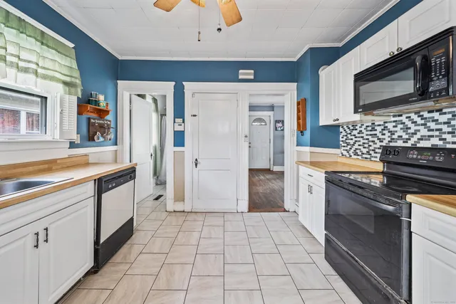 a kitchen with stainless steel appliances kitchen island granite countertop a stove a sink and a microwave