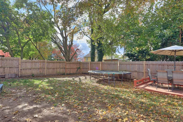 a view of a backyard with a small cabin and a chair