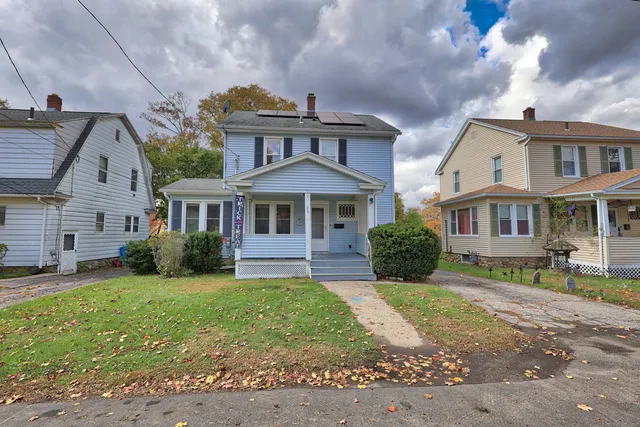 a front view of a house with a yard