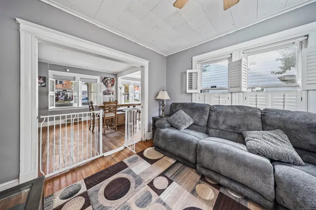 a living room with furniture and a floor to ceiling window