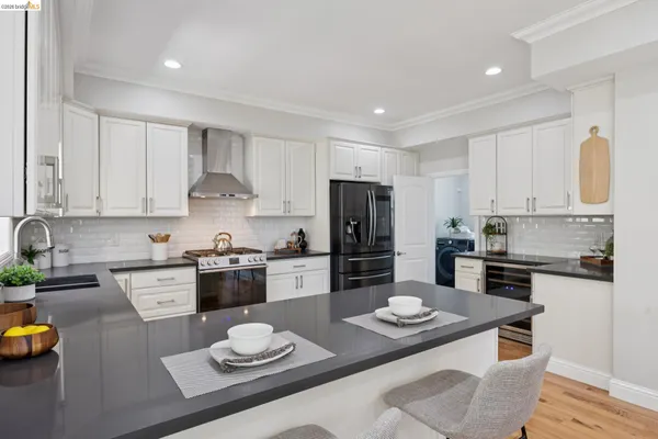 a kitchen with stainless steel appliances granite countertop a sink stove and refrigerator