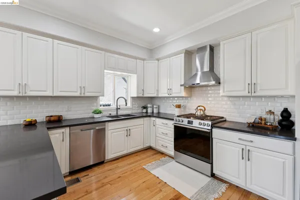a kitchen with stainless steel appliances granite countertop a sink and cabinets