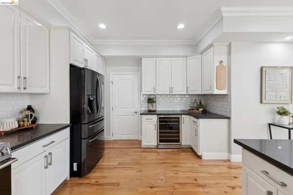 a kitchen with a refrigerator and a stove top oven