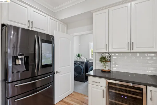 a kitchen with a refrigerator and cabinets