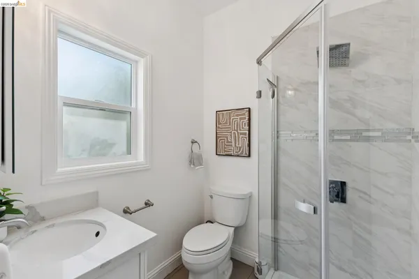 a bathroom with a toilet sink and shower