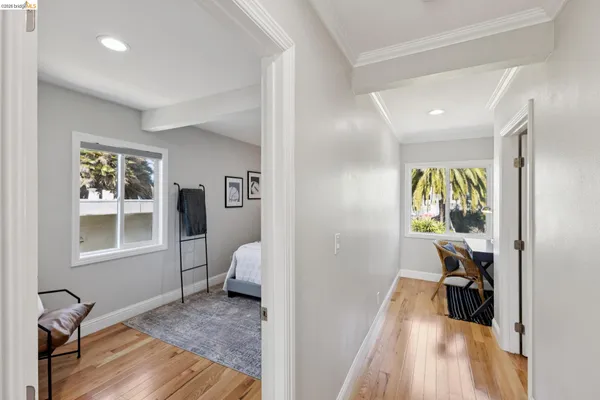 a view of a bedroom with wooden floor and a window