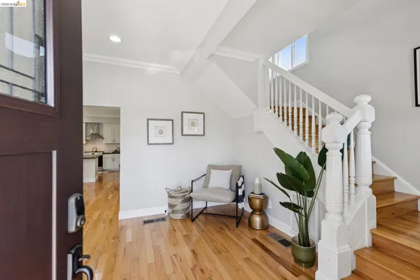 a view of entryway livingroom and hall with wooden floor