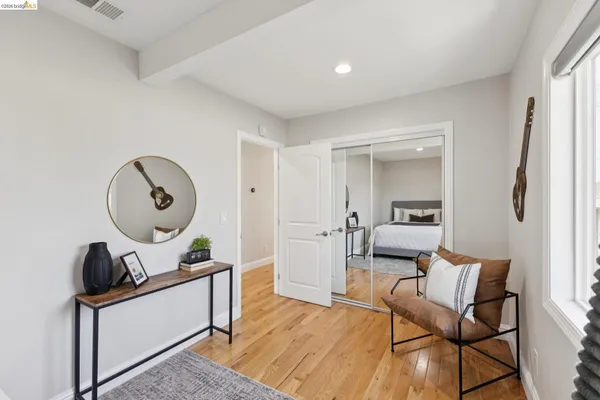 a living room with furniture and a mirror