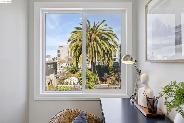 a view of a balcony with chair and a potted plant