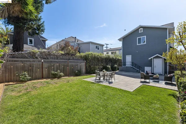a view of a backyard with sitting area and furniture