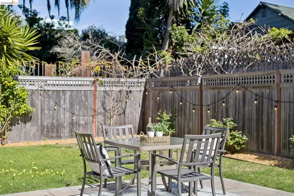 a view of outdoor dining space with a patio and a garden
